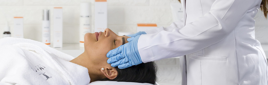 Woman receiving a professional facial treatment in a clinic.